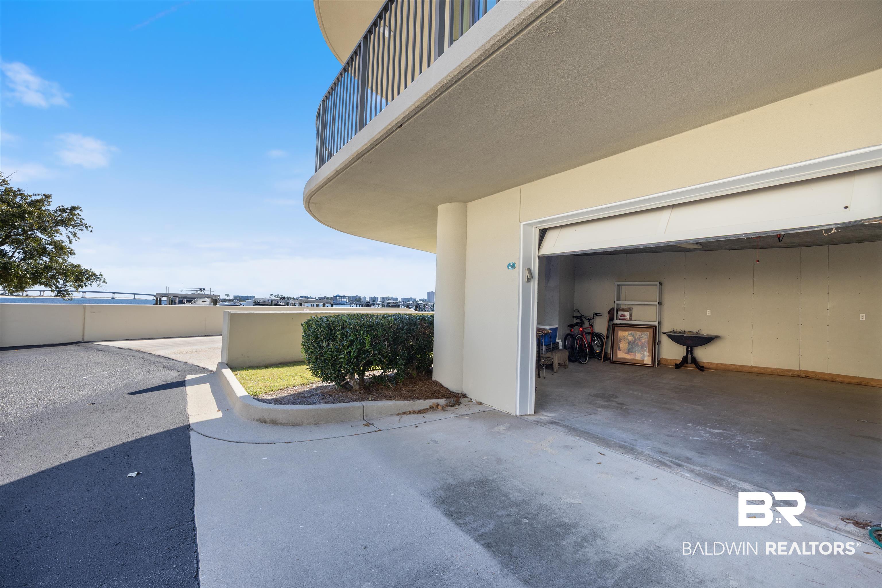 27580 Canal Road, Unit 1431 Orange Beach, AL 36561 - Photo 44 of 73 Exterior space with a patio area, a balcony, stucco siding, and concrete driveway