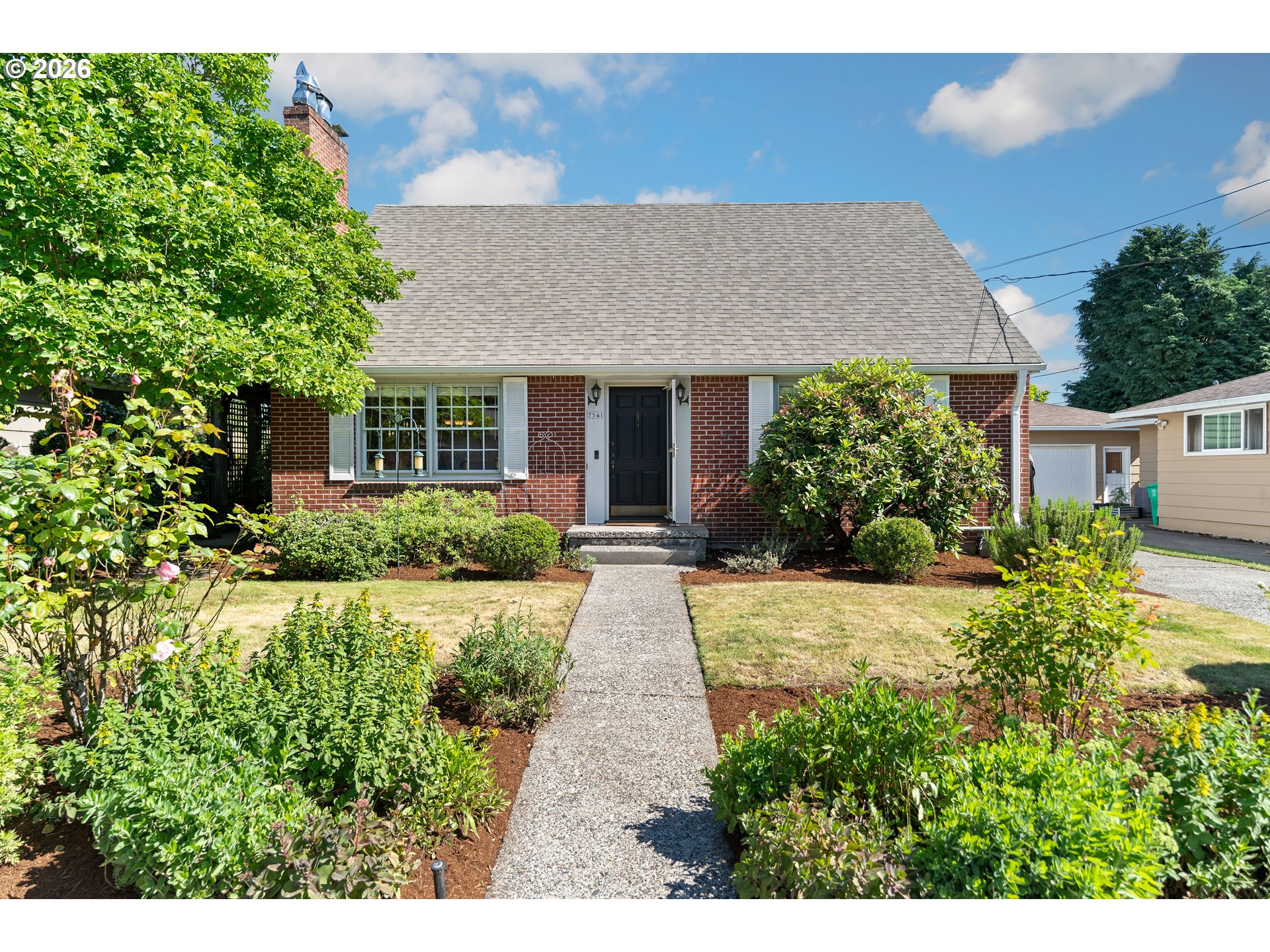 a view of a house with potted plants