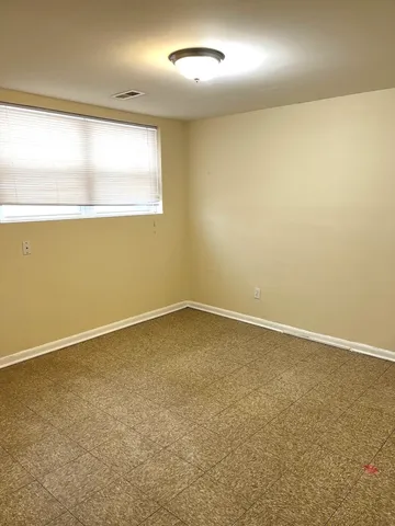 an empty room with a empty space and a window