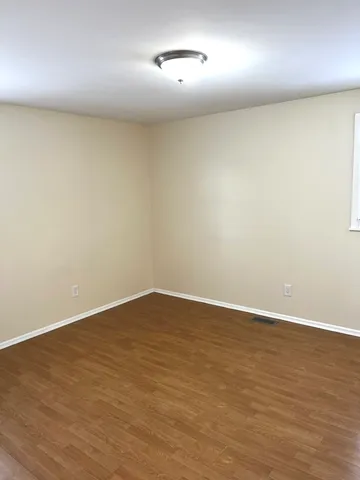 an empty room with a empty space and a wooden floor