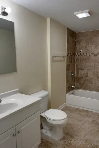 a bathroom with a toilet a sink and bathtub