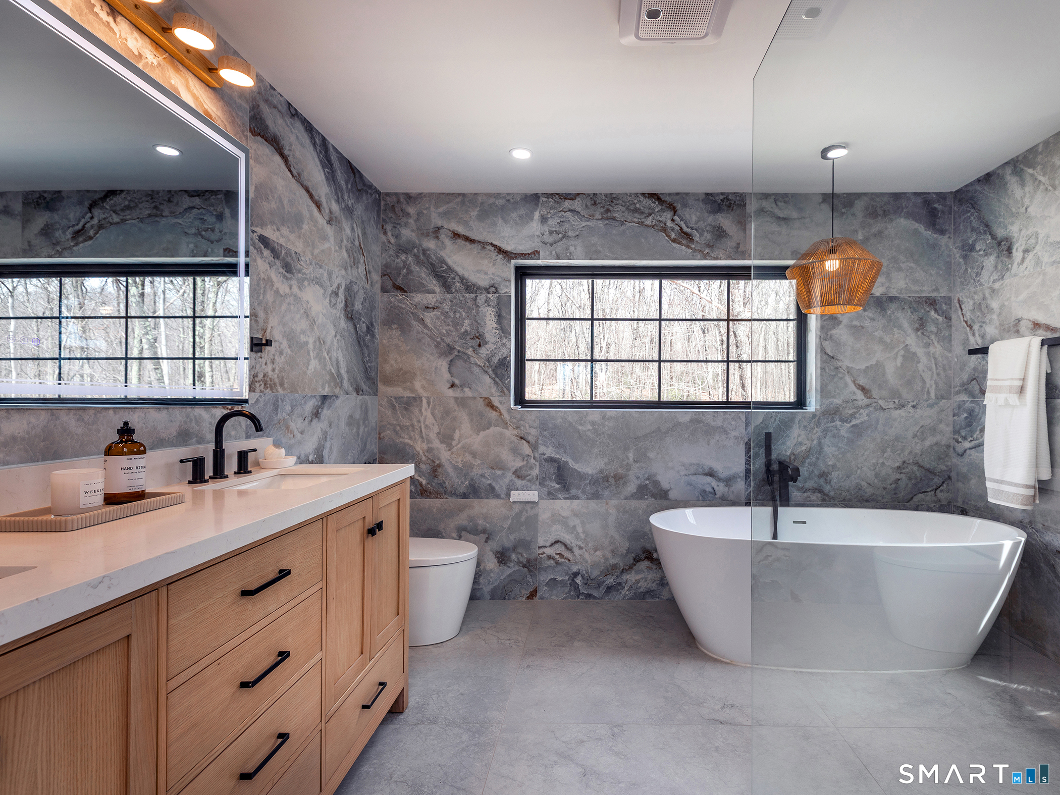 53 Mountain Lake Road Warren, CT 06777 - Photo 21 of 40 a spacious bathroom with a double vanity sink mirror and a bathtub