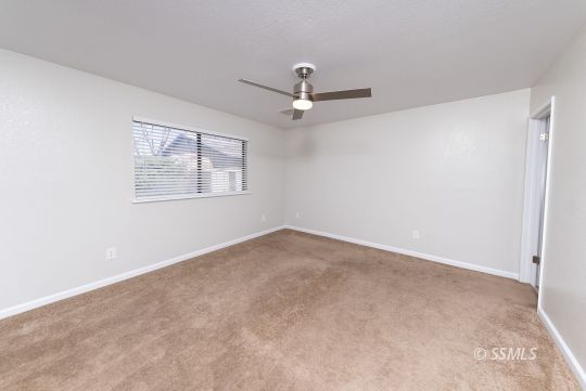 318 Reese Street Ridgecrest, CA 93555 - Photo 15 of 34 an empty room with windows and fan