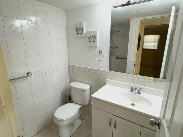 a bathroom with a toilet sink and shower