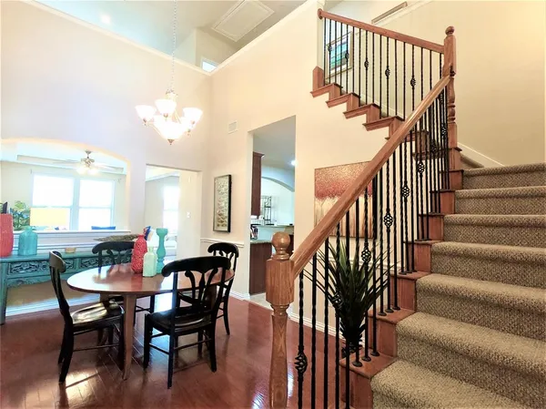 a view of staircase with dining table and chairs