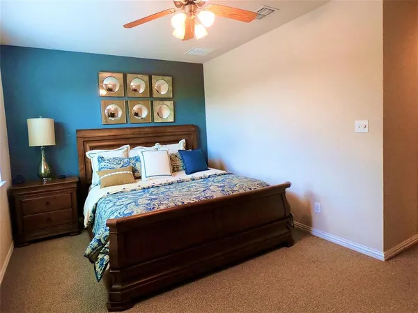 a bedroom with a bed and a lamp