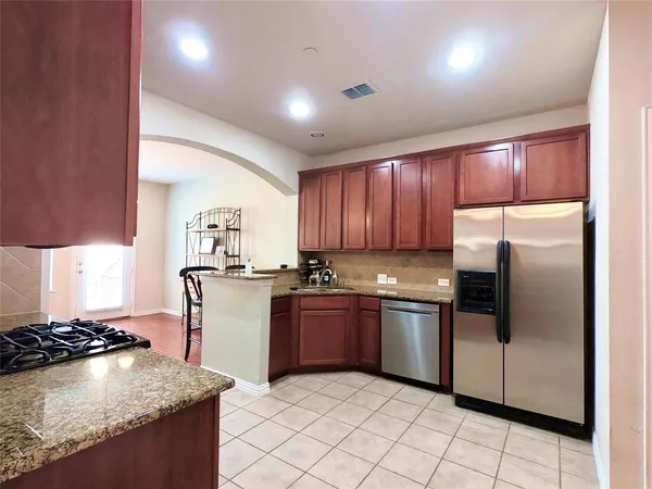 a kitchen with a stove sink and refrigerator