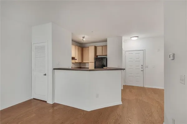 an empty room with wooden floor and window