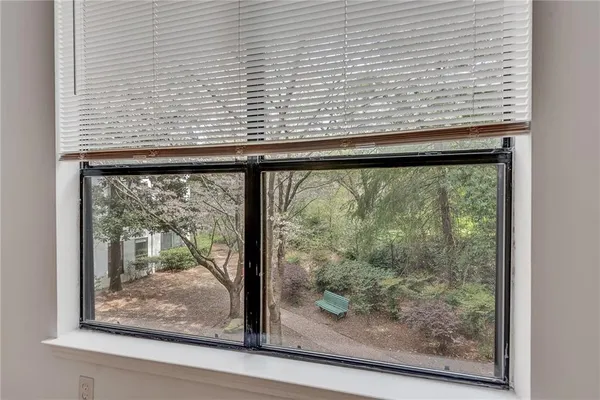 a view of a room with wooden floor and window