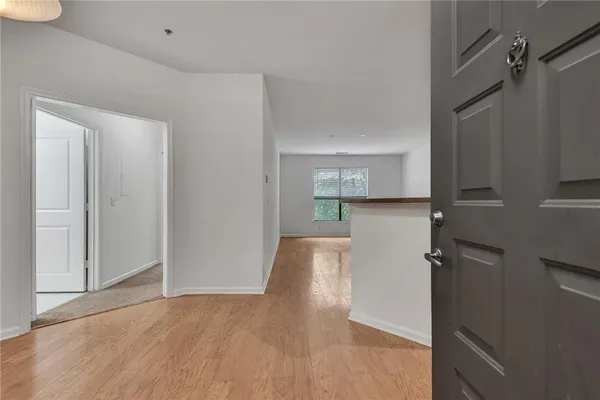 a view of hallway with wooden floor