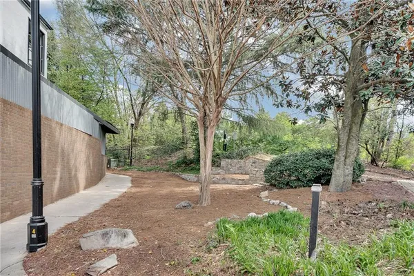 a white building that has a tree on the side of it
