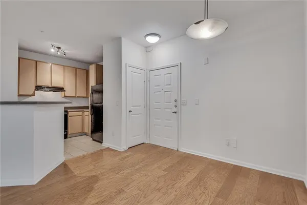 a view of a kitchen with a sink and dishwasher a refrigerator with wooden floor