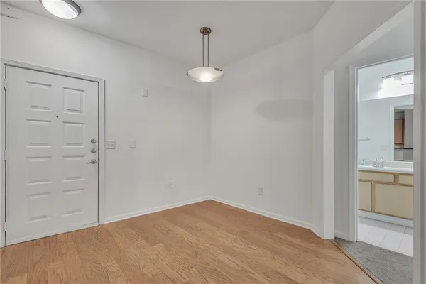 wooden floor in an empty room with a mirror
