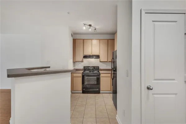 a kitchen with stainless steel appliances a refrigerator and a stove