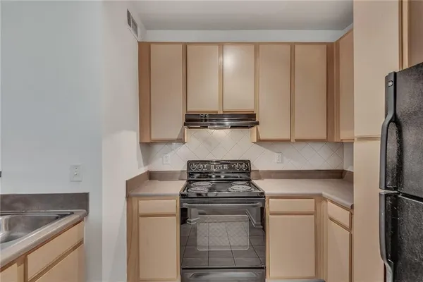 a kitchen with appliances cabinets and a sink