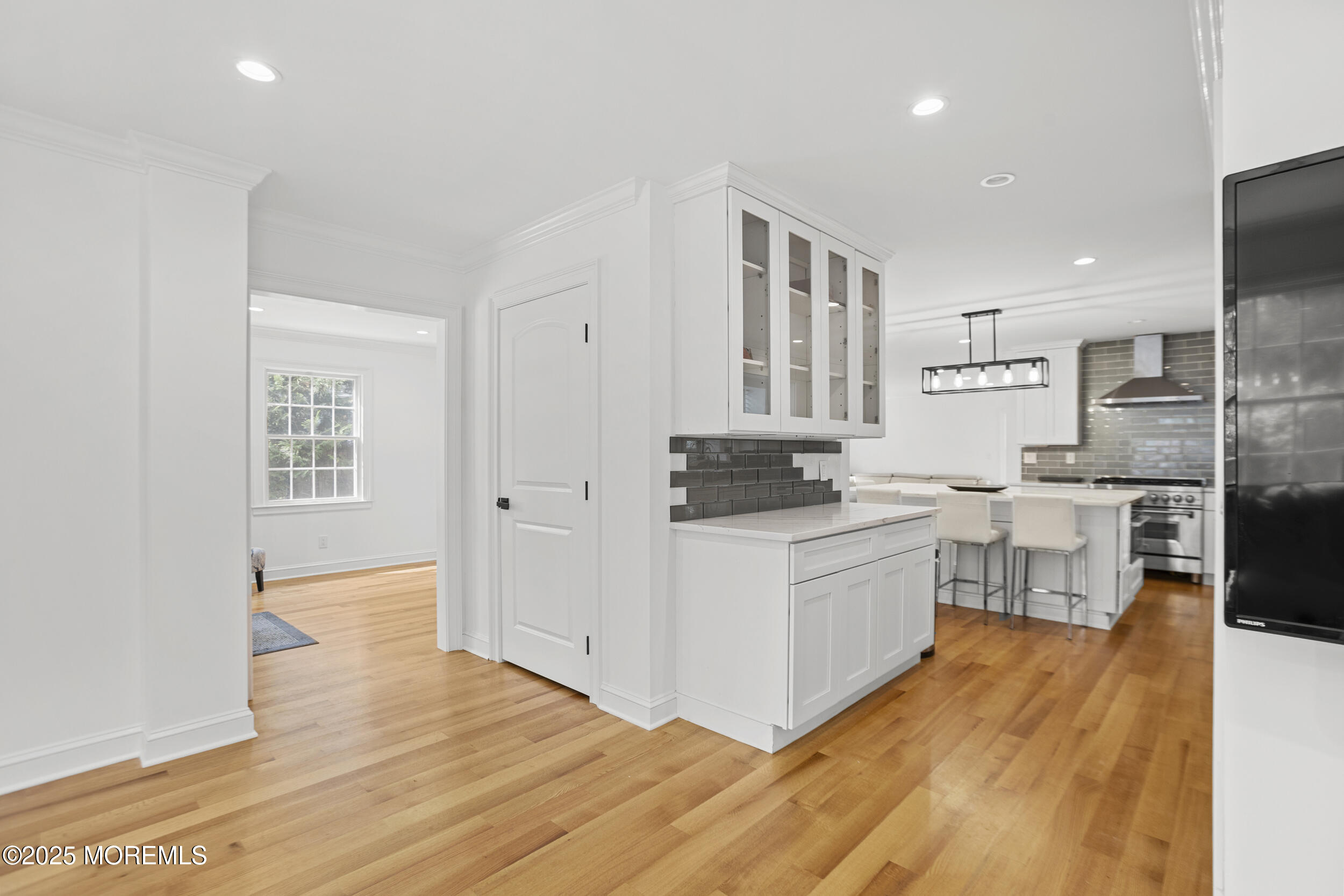 196 Highwood Road Oakhurst, NJ 07755 - Photo 7 of 32 a kitchen with white cabinets and stainless steel appliances