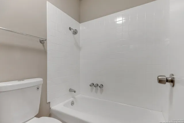 a bathroom with a bathtub and a toilet