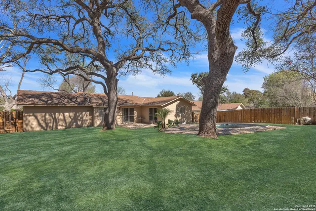 a view of a yard with a house in the background