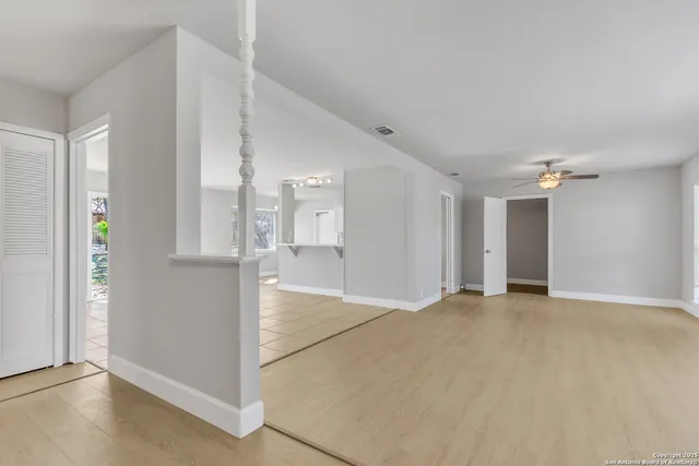a view of empty room with wooden floor