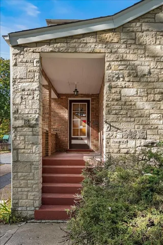 a front view of a building with a garden