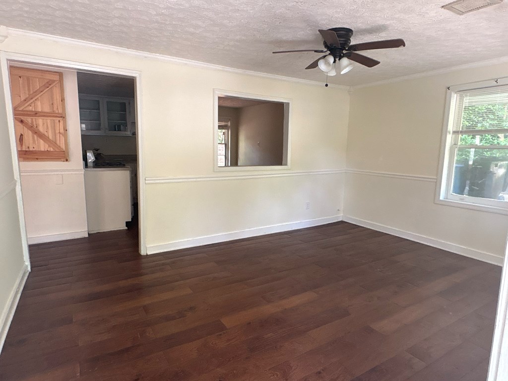 2910 Beech Street Columbus, GA 31909 - Photo 3 of 24 a view of a livingroom with wooden floor and a ceiling fan