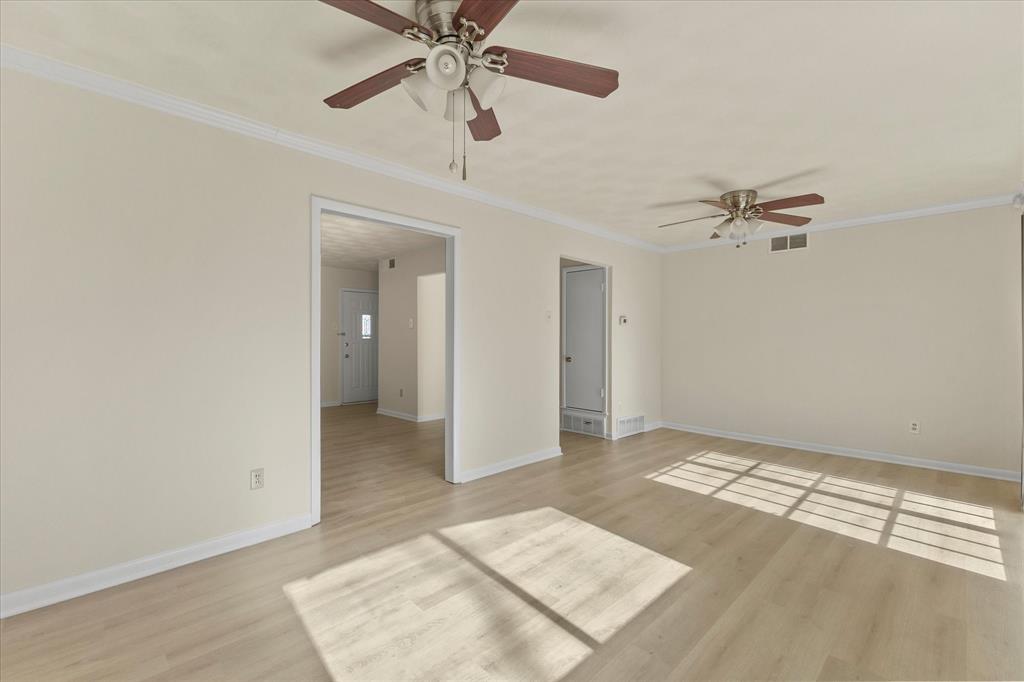 4110 Colgate Lane Garland, TX 75042 - Photo 11 of 22 wooden floor in an empty room with a chandelier fan
