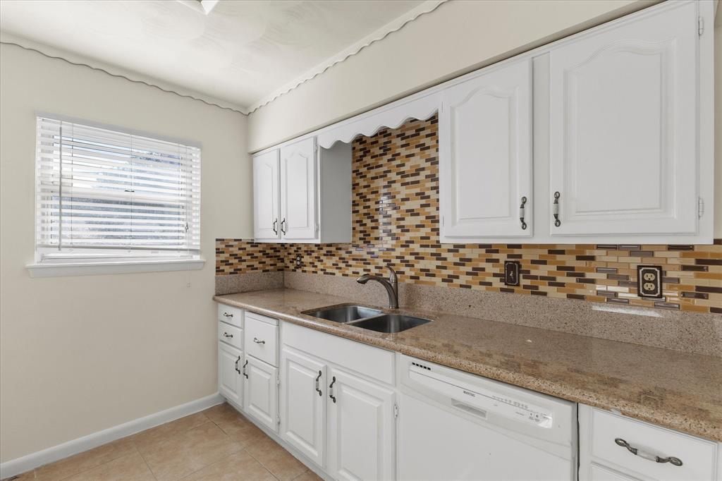 4110 Colgate Lane Garland, TX 75042 - Photo 12 of 22 a kitchen with granite countertop white cabinets and a sink