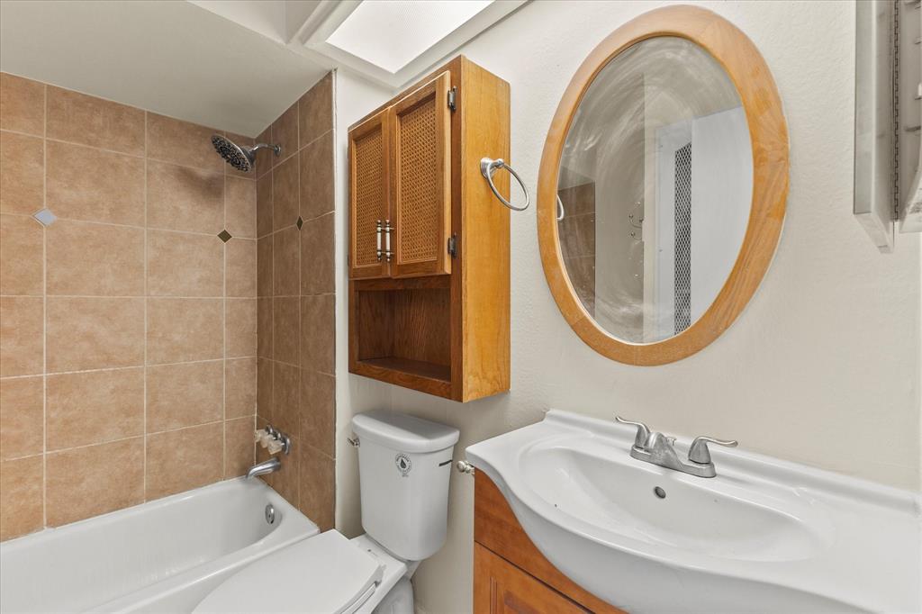 4110 Colgate Lane Garland, TX 75042 - Photo 14 of 22 a bathroom with a sink a toilet and a mirror