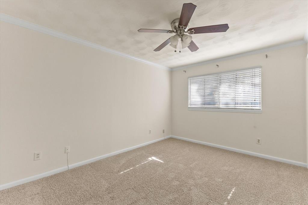 4110 Colgate Lane Garland, TX 75042 - Photo 20 of 22 an empty room with a ceiling fan and window