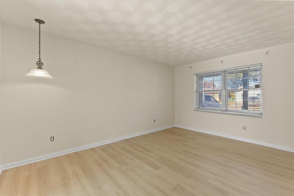 4110 Colgate Lane Garland, TX 75042 - Photo 10 of 22 a view of an empty room with window and wooden floor