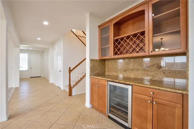 a kitchen with stainless steel appliances granite countertop a sink and a refrigerator