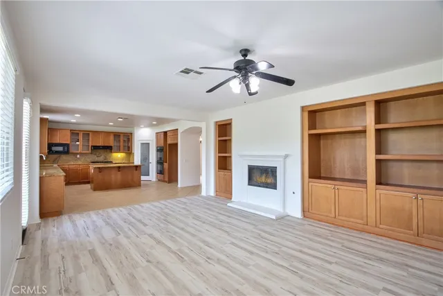a view of hallway with a large window and wooden floor