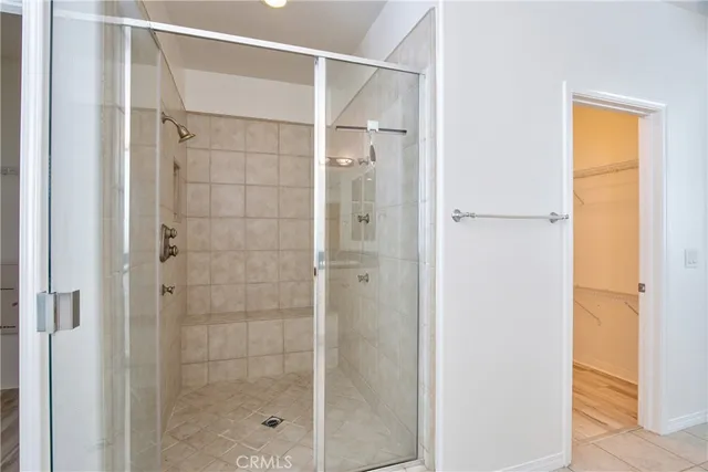 an empty room with a window and a ceiling fan