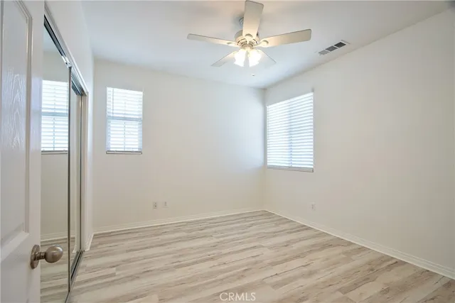 a view of a house with a yard and lawn chairs