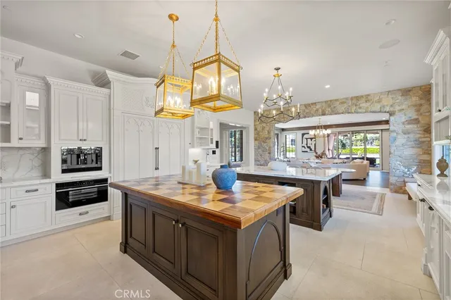 a kitchen that has a stove and a chandelier