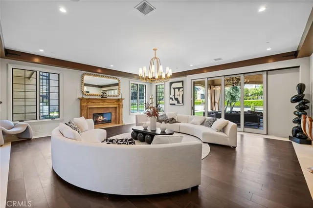 a bathroom with a double vanity sink a large mirror and a bathtub
