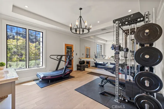 a spacious bedroom with a bed and a chandelier