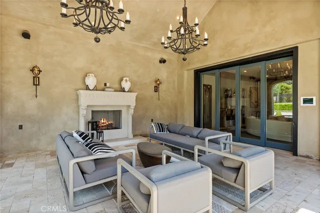 a living room with furniture and a chandelier