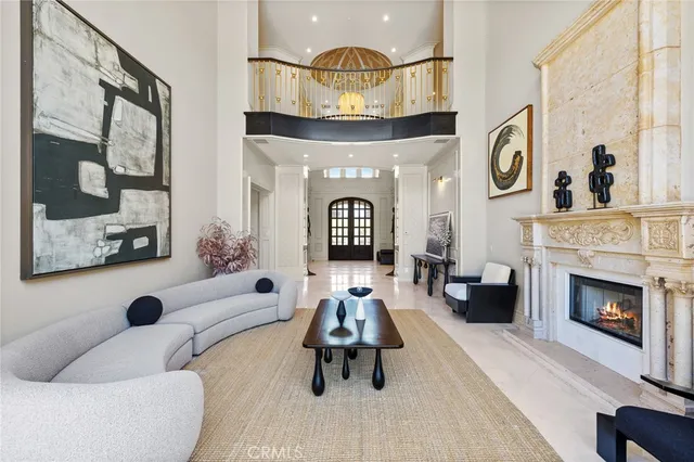 a very nice looking dining room with kitchen island furniture a large window and a chandelier
