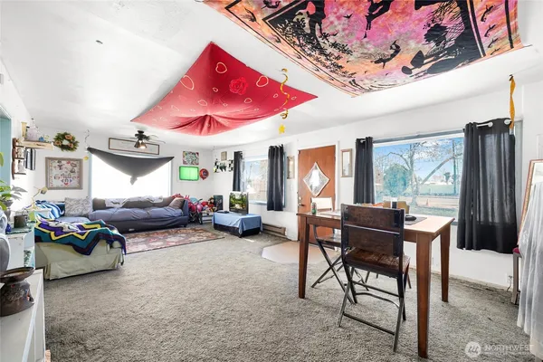 a bedroom with furniture and a large window