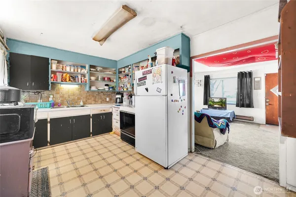 a kitchen with a refrigerator and a sink