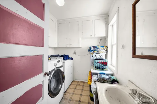 a utility room with sink dryer and washer