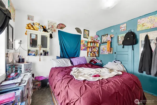 a bedroom with bed and a flat screen tv