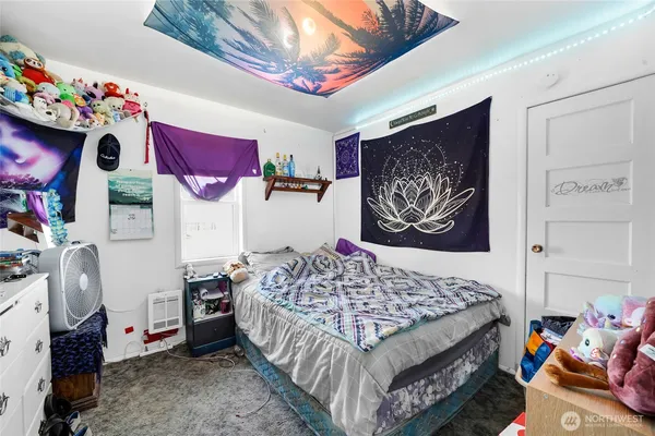 a bedroom with a bed and a couch