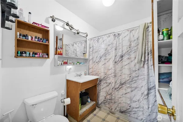 a bathroom with a sink a toilet and mirror