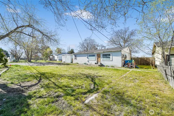 a swimming pool with trees in front of it
