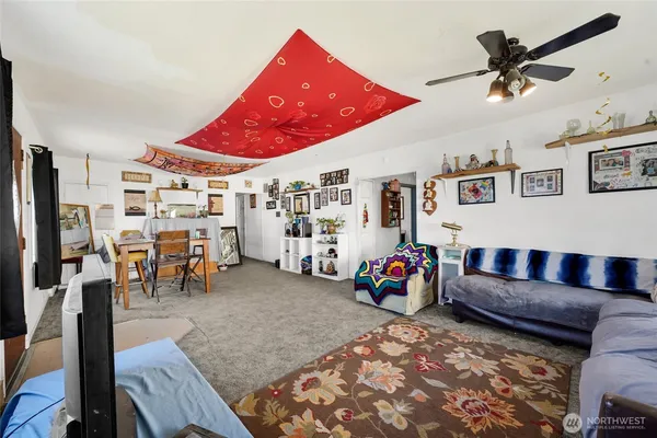 a living room with furniture and kitchen view