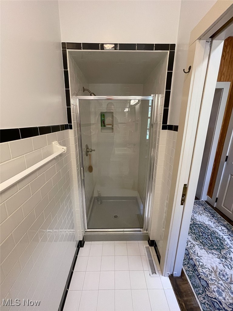 80725 Mallarnee Road Freeport, OH 43973 - Photo 18 of 29 Full bathroom with a shower stall, tile patterned flooring, and tile walls