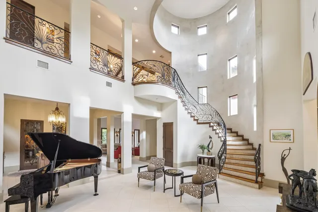 a living room with furniture and a chandelier