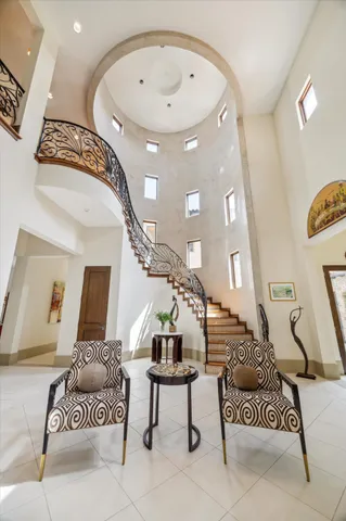 a kitchen with stainless steel appliances granite countertop a stove a sink a refrigerator and chairs